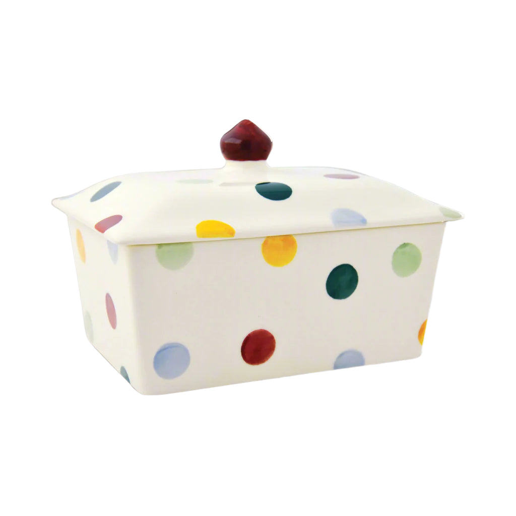 Ceramic butter dish with colourful polka dots and a smooth lid, adding a playful touch to kitchen decor.
